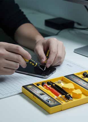 Persona usando set 38 en 1 para reparación de electrónicos