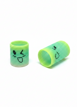 Resorte mágico slinky verde kawaii flat lay comprimido y extendido juguete sensorial